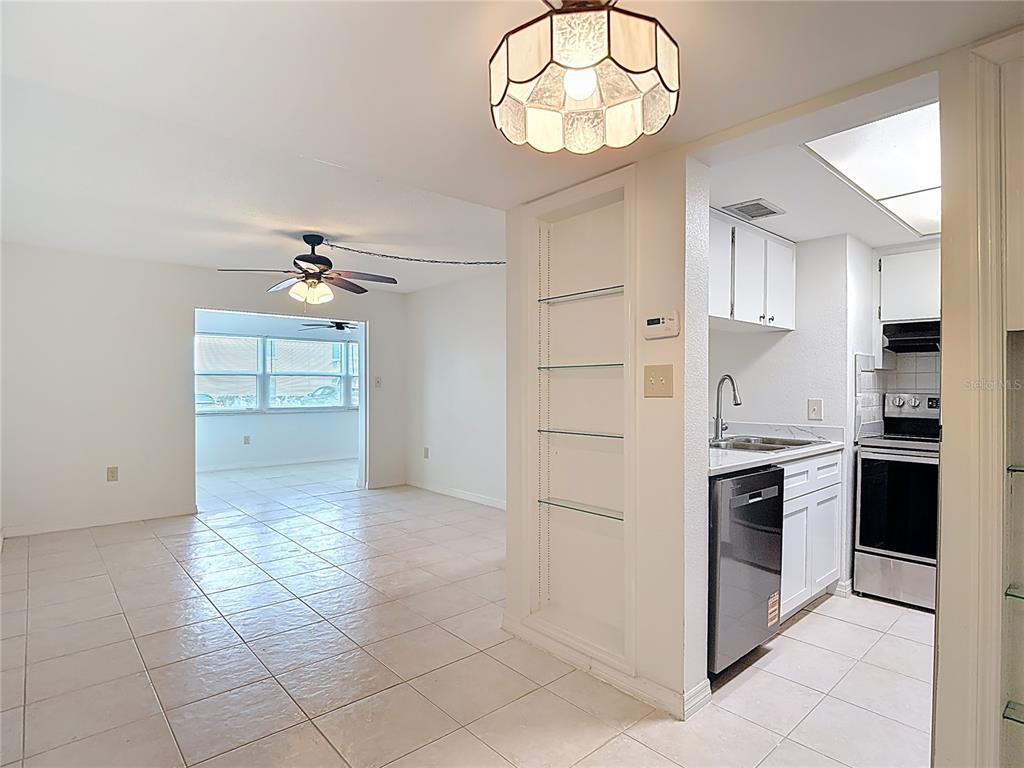 5132 Amulet Drive, Unit 105 New Port Richey, FL 34652 - Photo 11 of 42 an empty room with kitchen and stainless steel appliances