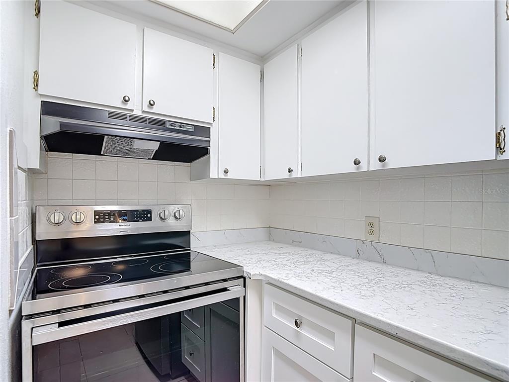 5132 Amulet Drive, Unit 105 New Port Richey, FL 34652 - Photo 15 of 42 a kitchen with appliances and cabinets