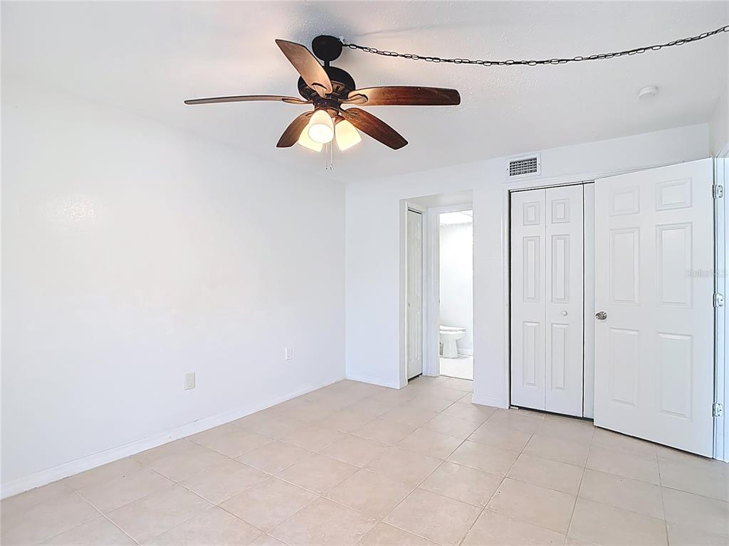 5132 Amulet Drive, Unit 105 New Port Richey, FL 34652 - Photo 19 of 42 a view of a big room with a ceiling fan and a window
