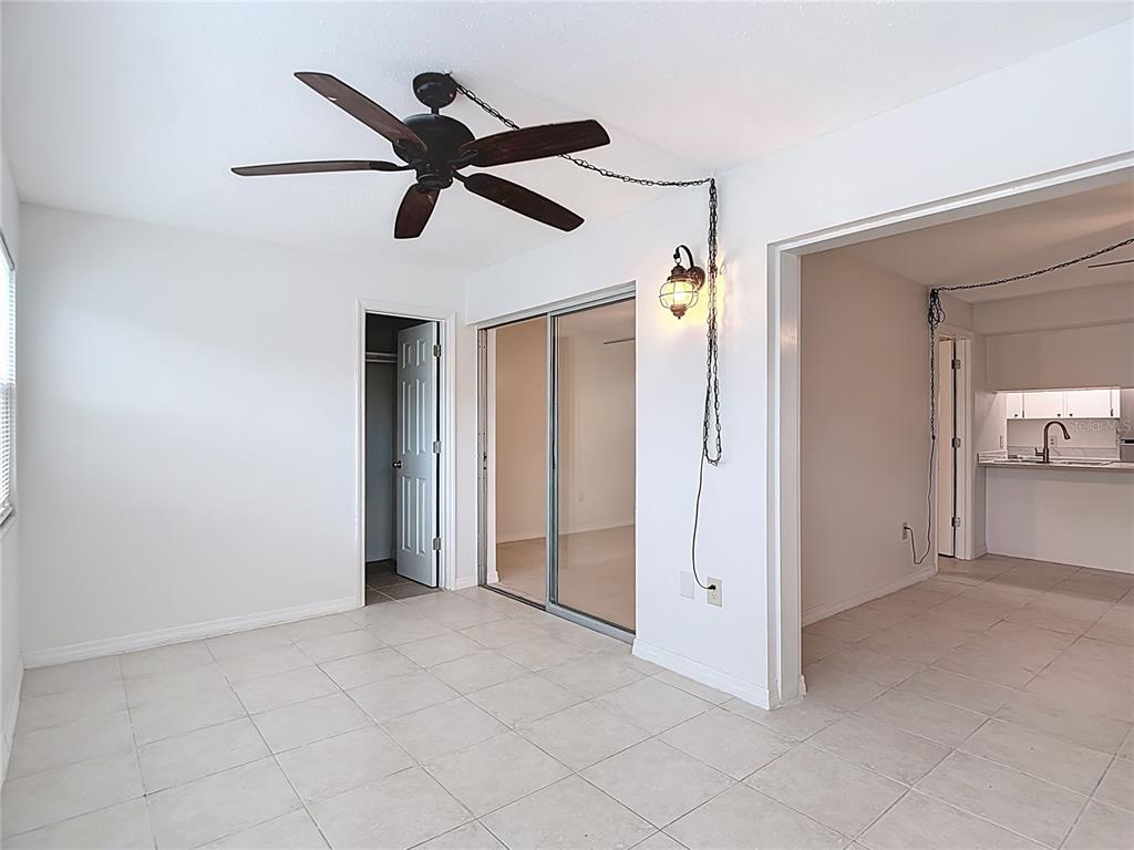 5132 Amulet Drive, Unit 105 New Port Richey, FL 34652 - Photo 2 of 42 wooden floor in an empty room and a ceiling fan