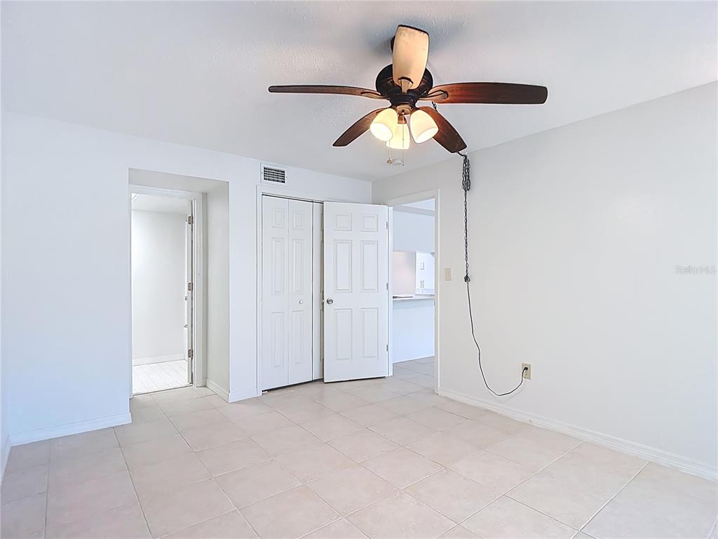 5132 Amulet Drive, Unit 105 New Port Richey, FL 34652 - Photo 21 of 42 a view of a room with a ceiling fan and a fan