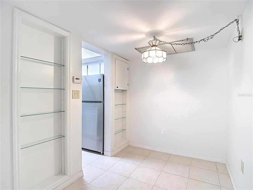 5132 Amulet Drive, Unit 105 New Port Richey, FL 34652 - Photo 28 of 42 a view of a kitchen with closet and a refrigerator