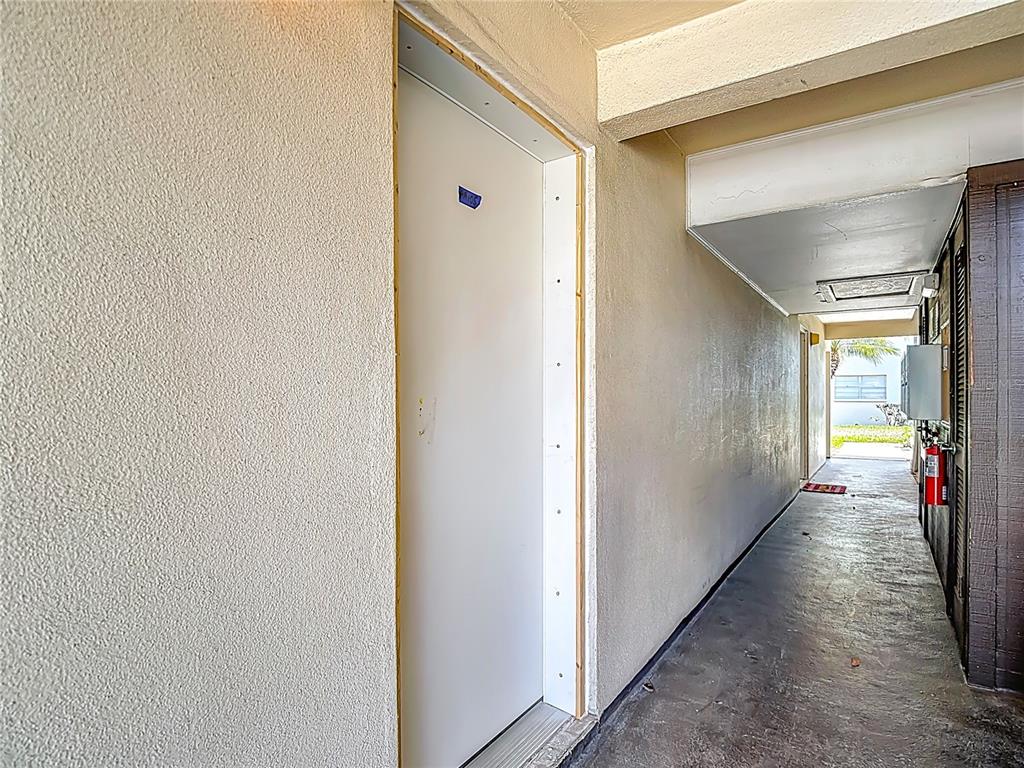 5132 Amulet Drive, Unit 105 New Port Richey, FL 34652 - Photo 31 of 42 a view of a hallway with the windows