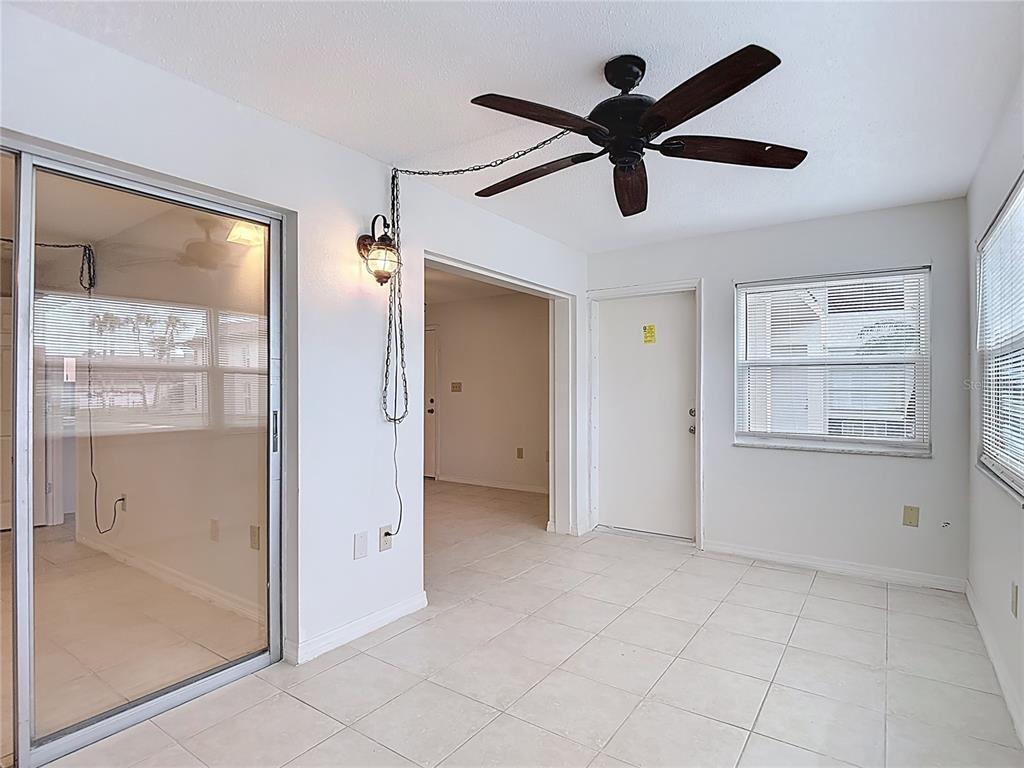 5132 Amulet Drive, Unit 105 New Port Richey, FL 34652 - Photo 9 of 42 a view of empty room with wooden floor and windows