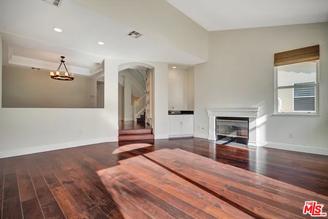 a spacious bedroom with a bed and a fireplace