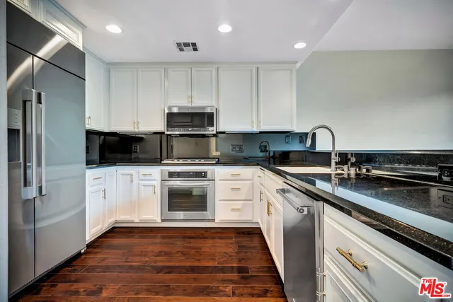 a kitchen with a sink stove and refrigerator