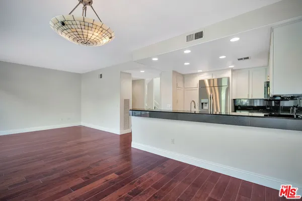 a view of a kitchen with a sink and microwave