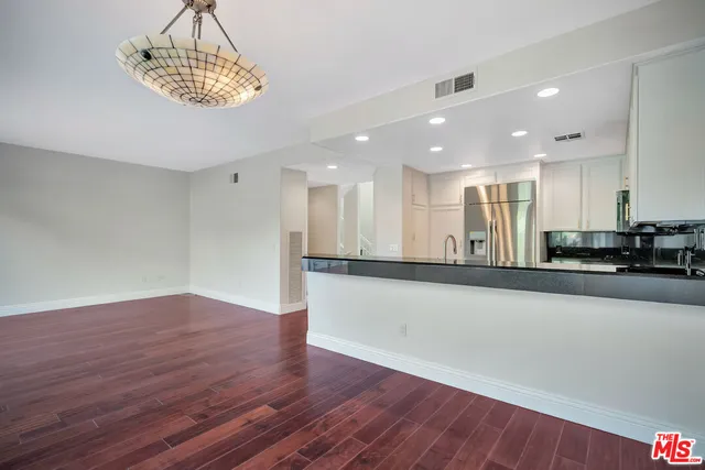 a view of a kitchen with a sink and microwave