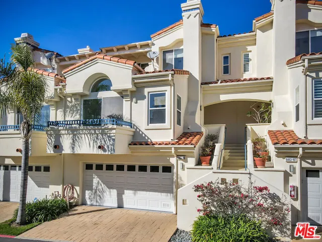 a front view of multiple houses with glass windows