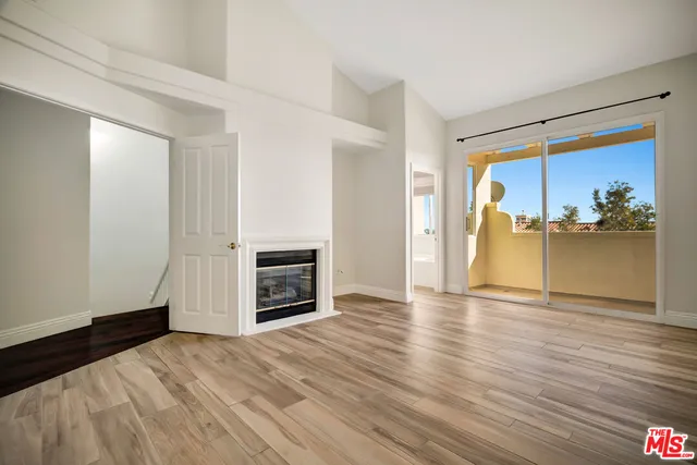 a view of a livingroom with a fireplace and wooden floor