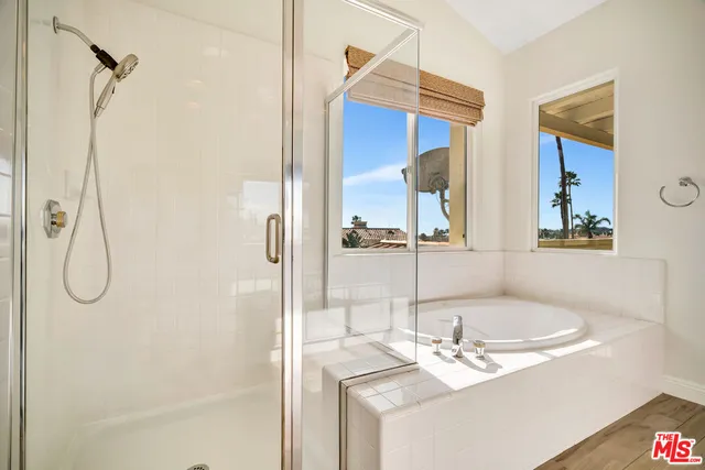 a bathroom with a tub and a shower