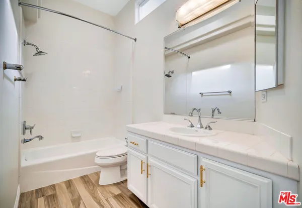 a bathroom with a sink a toilet and a bathtub