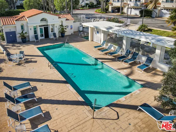 an aerial view of a house with backyard space and balcony