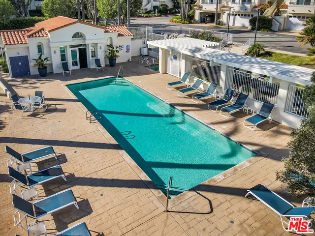 an aerial view of a house with backyard space and balcony