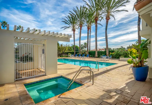 a view of swimming pool with a lounge chairs