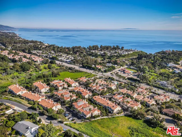 an aerial view of residential building and ocean