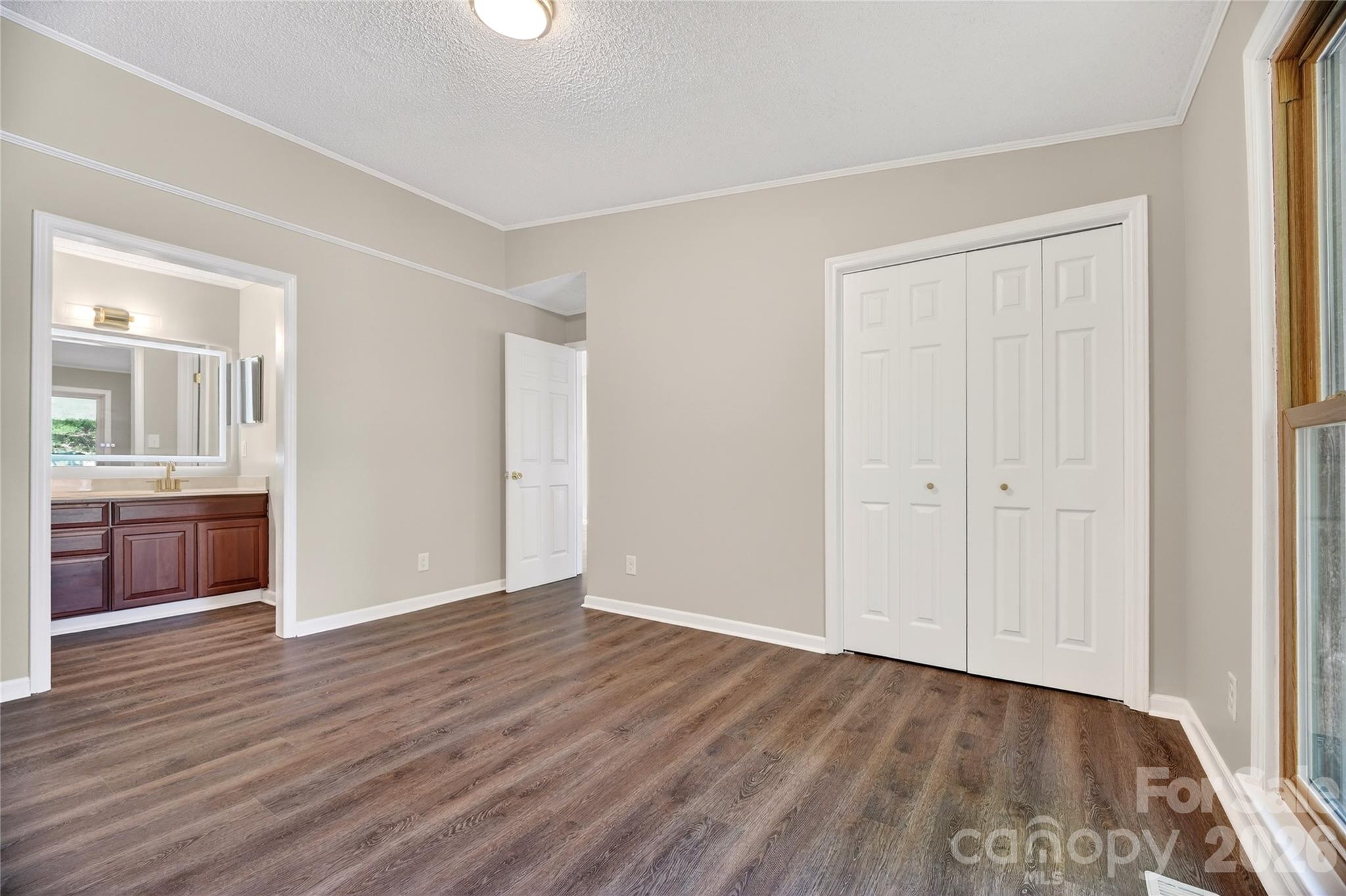 1919 Oak Hollow Road Gastonia, NC 28054 - Photo 19 of 36 a view of a kitchen and an empty room with wooden floor