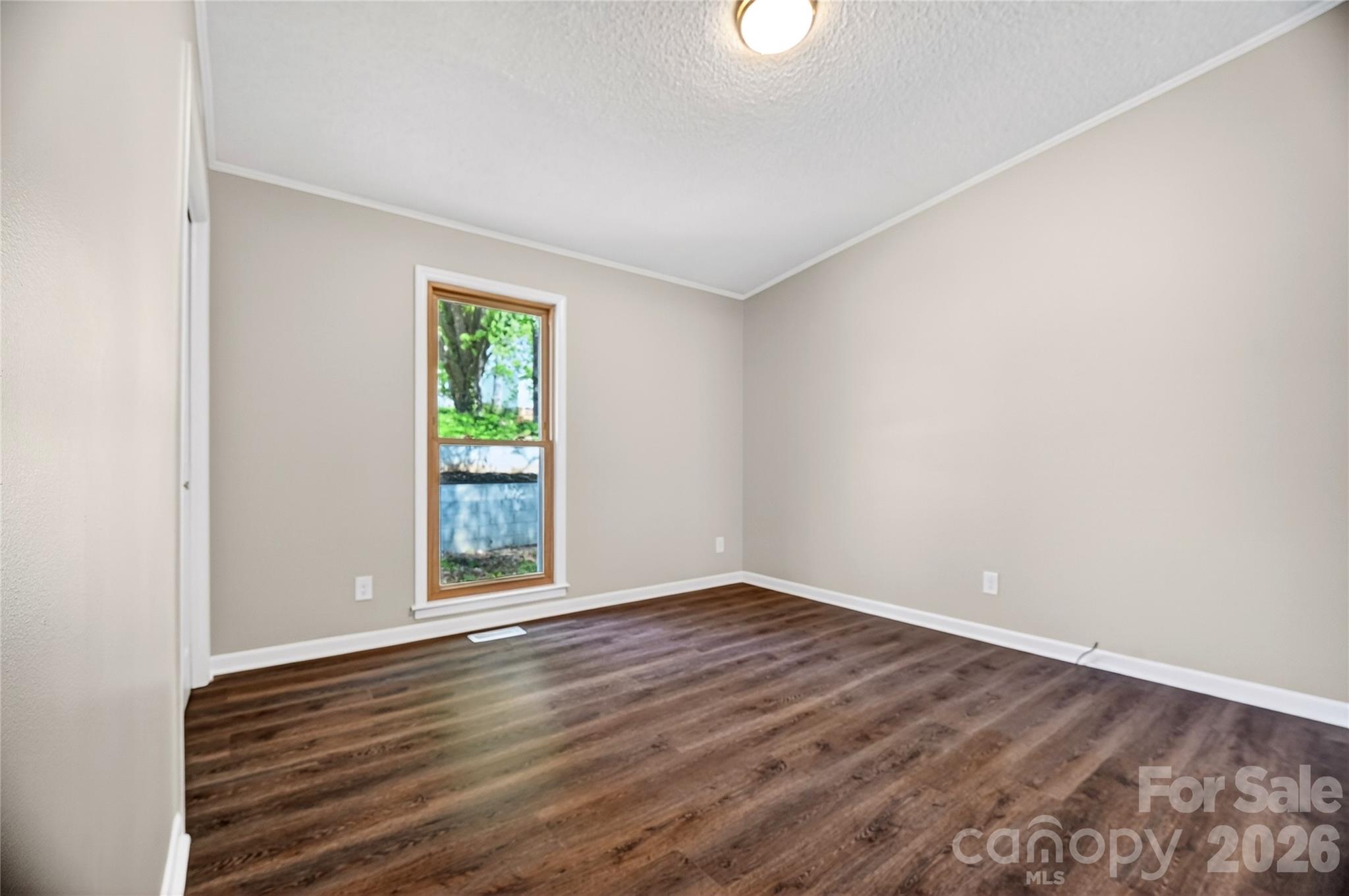 1919 Oak Hollow Road Gastonia, NC 28054 - Photo 24 of 36 an empty room with wooden floor and windows