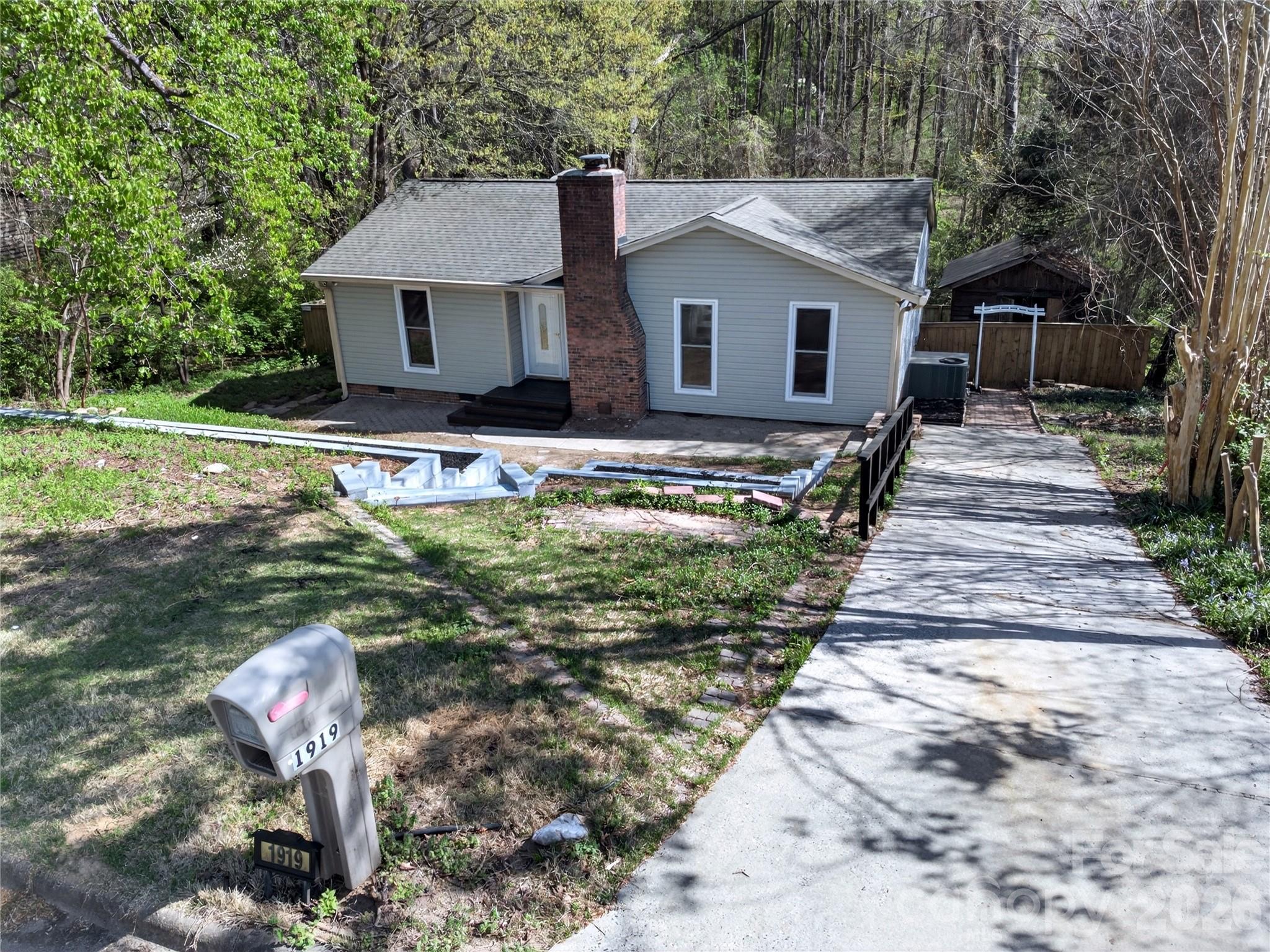 1919 Oak Hollow Road Gastonia, NC 28054 - Photo 26 of 36 a front view of a house with a yard table and chairs