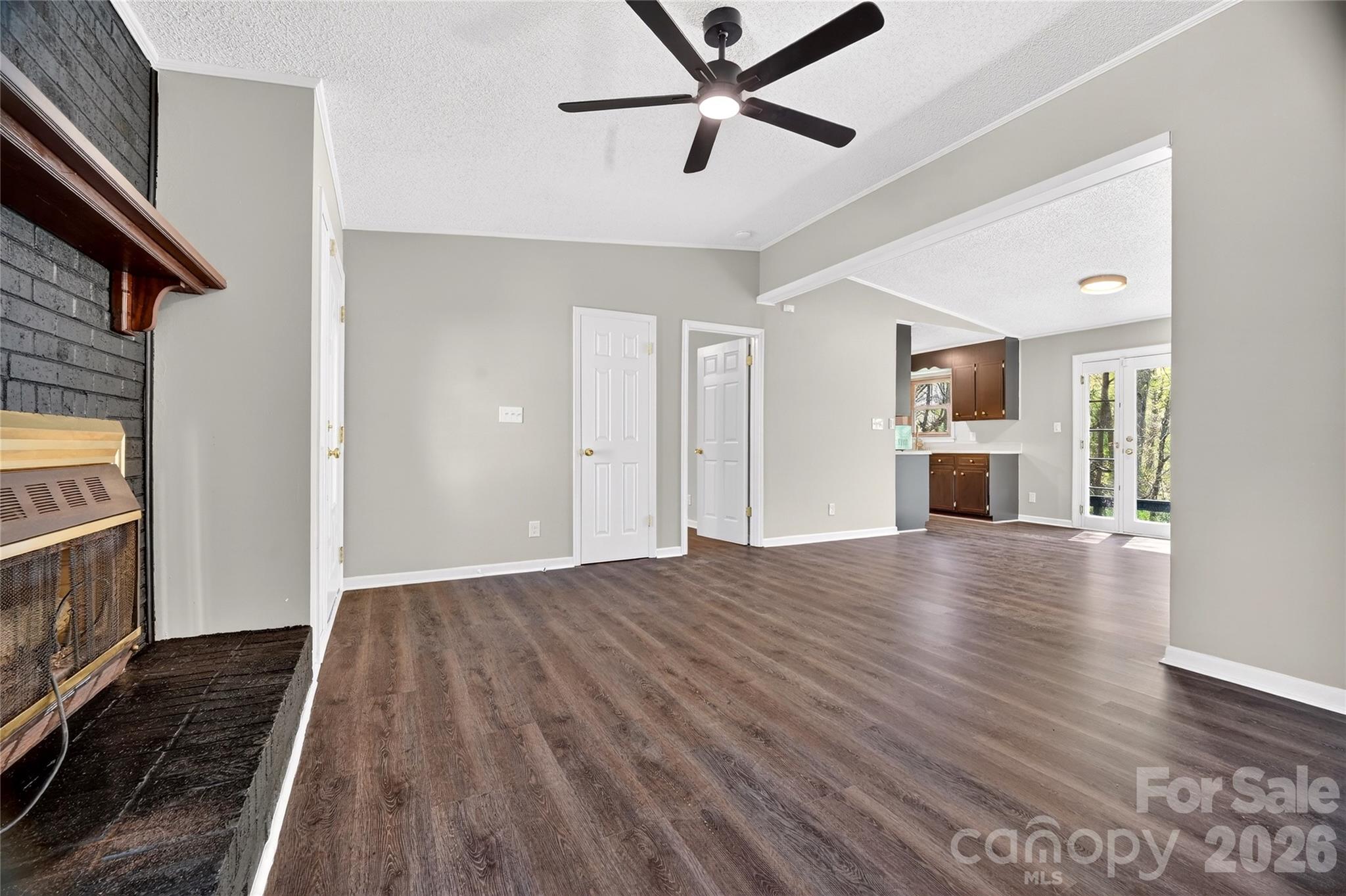 1919 Oak Hollow Road Gastonia, NC 28054 - Photo 10 of 36 a view of empty room with wooden floor and fireplace