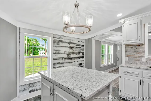 a kitchen with a window a sink and cabinets