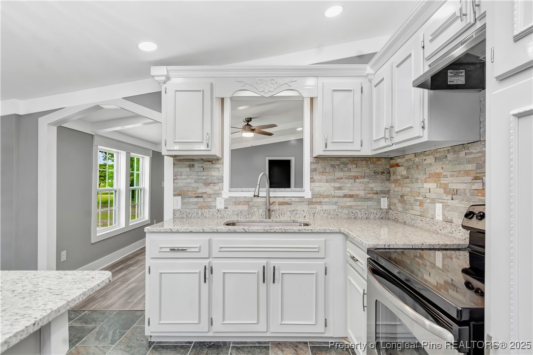 7225 Deep Branch Road Pembroke, NC 28372 - Photo 12 of 27 a kitchen with stainless steel appliances granite countertop a sink stove and cabinets