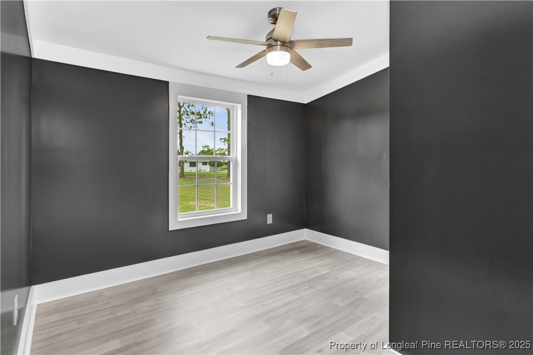 7225 Deep Branch Road Pembroke, NC 28372 - Photo 17 of 27 a view of an empty room with window and wooden floor