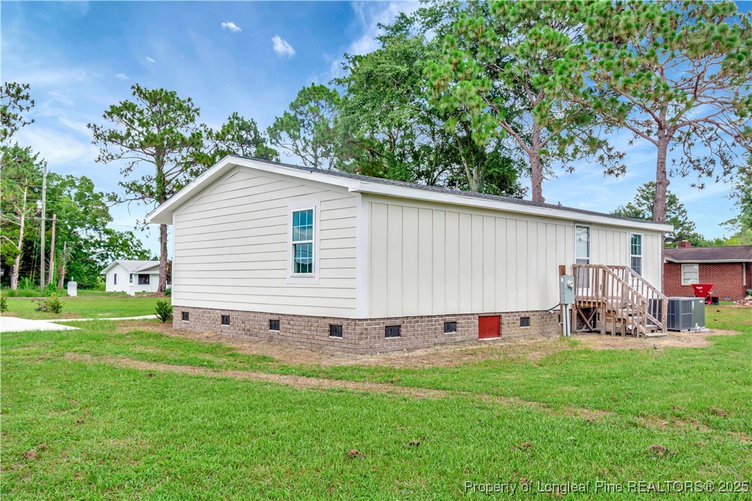7225 Deep Branch Road Pembroke, NC 28372 - Photo 25 of 27 a view of a house with backyard and sitting area