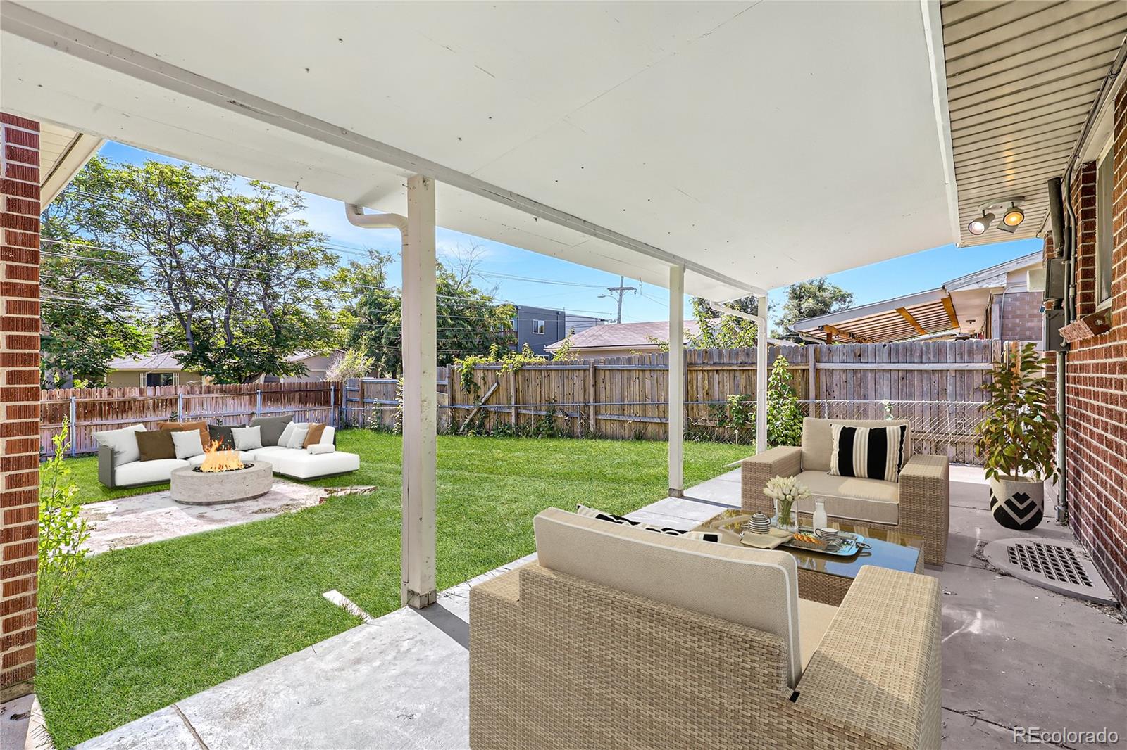 6930 North Locust Street Commerce City, CO 80022 - Photo 14 of 17 a view of a patio with couches chairs and a yard