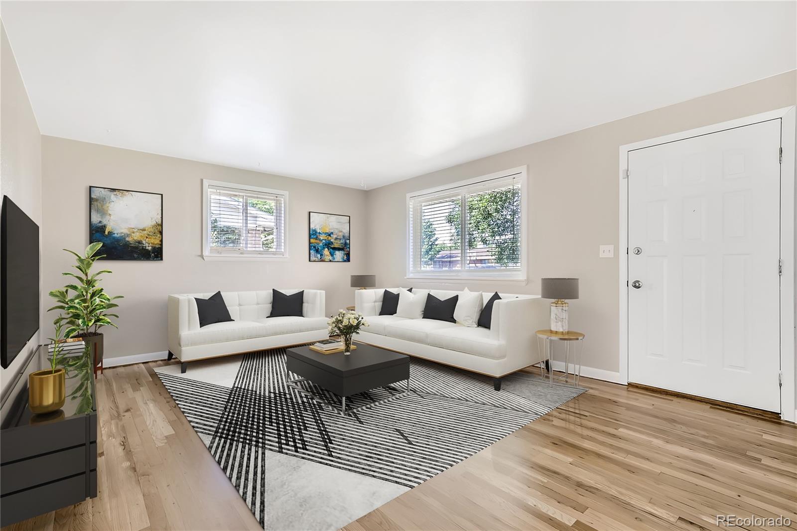 6930 North Locust Street Commerce City, CO 80022 - Photo 2 of 17 a living room with furniture wooden floor and a flat screen tv