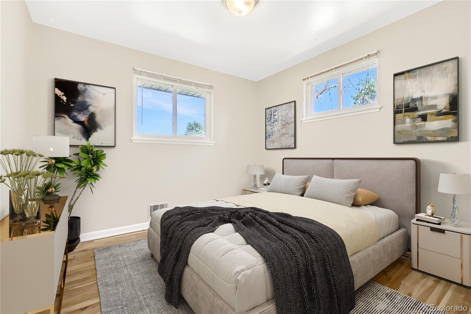 6930 North Locust Street Commerce City, CO 80022 - Photo 7 of 17 a bedroom with bed and a painting on the wall