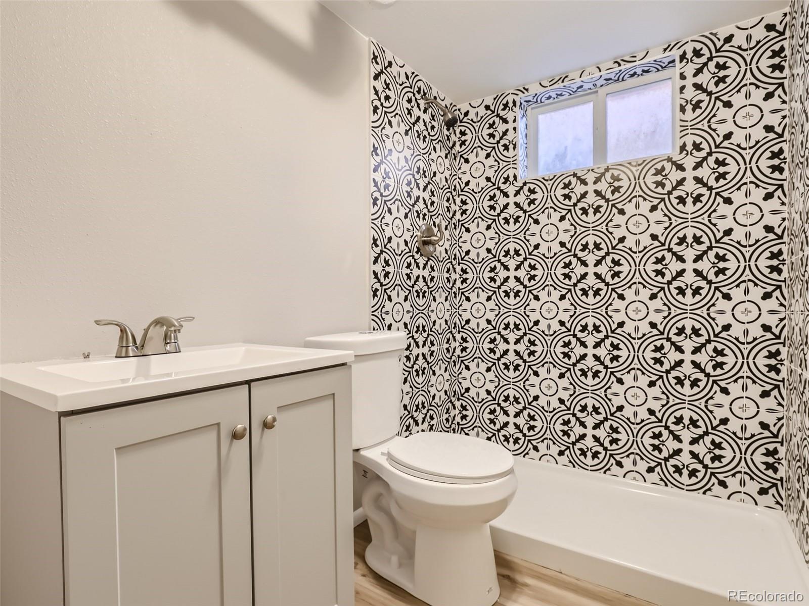 6930 North Locust Street Commerce City, CO 80022 - Photo 8 of 17 a bathroom with a toilet and a sink