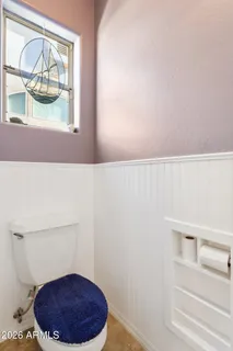 a bathroom with a double vanity sink mirror and toilet