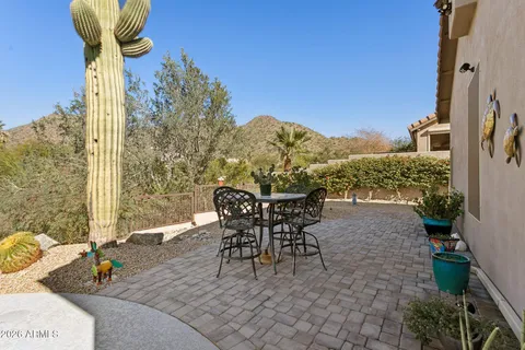a view of a house with swimming pool and sitting area
