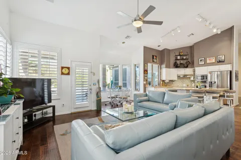 a living room with furniture a large window and a flat screen tv