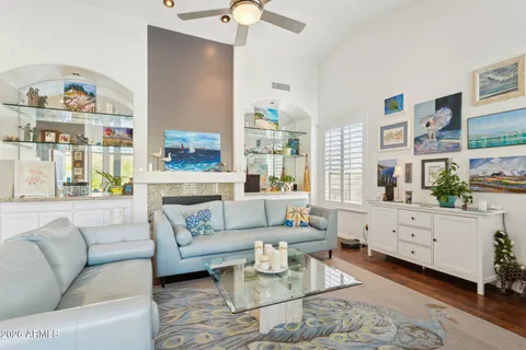 a living room with furniture and a painting on the wall