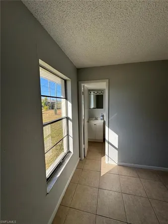 an empty room with windows and entrance