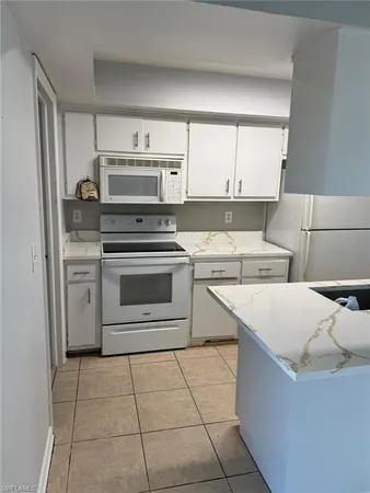 a kitchen with a stove a sink and a refrigerator