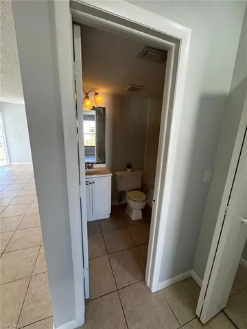 a view of a bathroom from a corridor