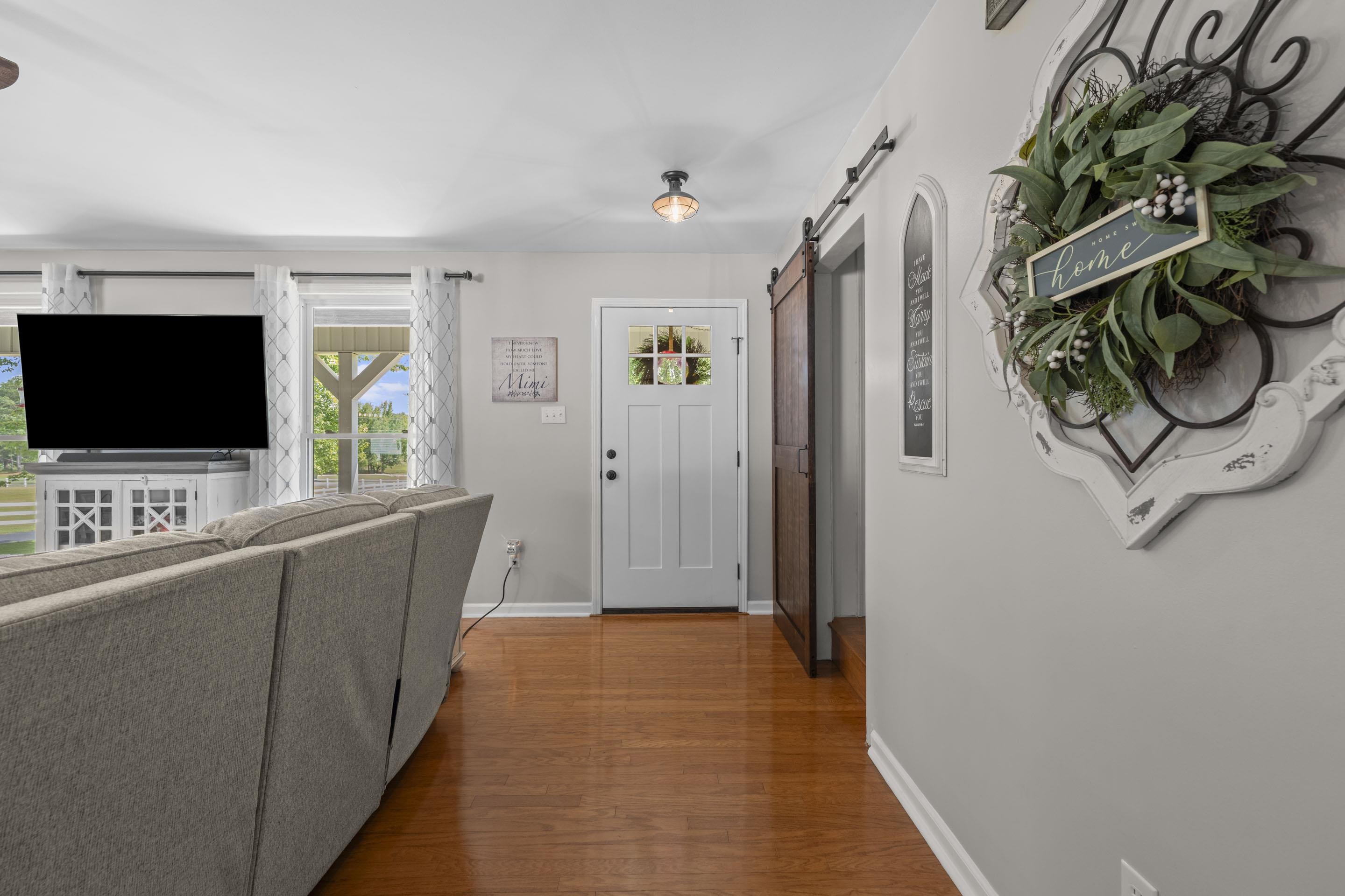 849 Belton Road Ripley, TN 38063 - Photo 11 of 40 a view of hallway with wooden floor and flat screen tv