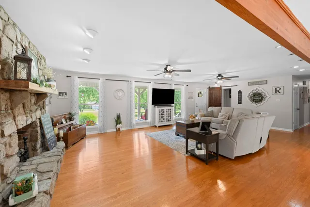 a kitchen with a stove and a wooden floor