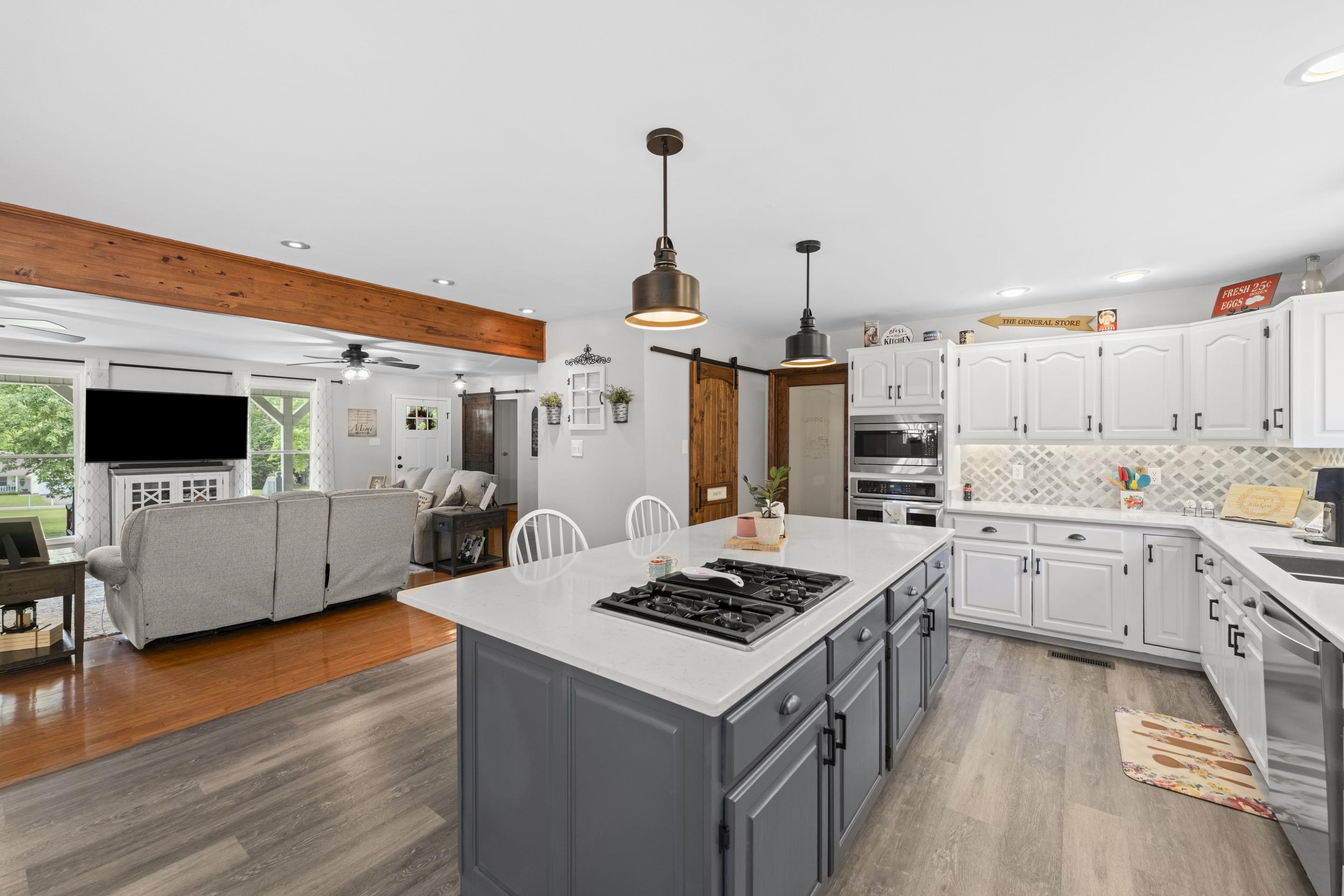 849 Belton Road Ripley, TN 38063 - Photo 14 of 40 a kitchen with a stove and a wooden floor