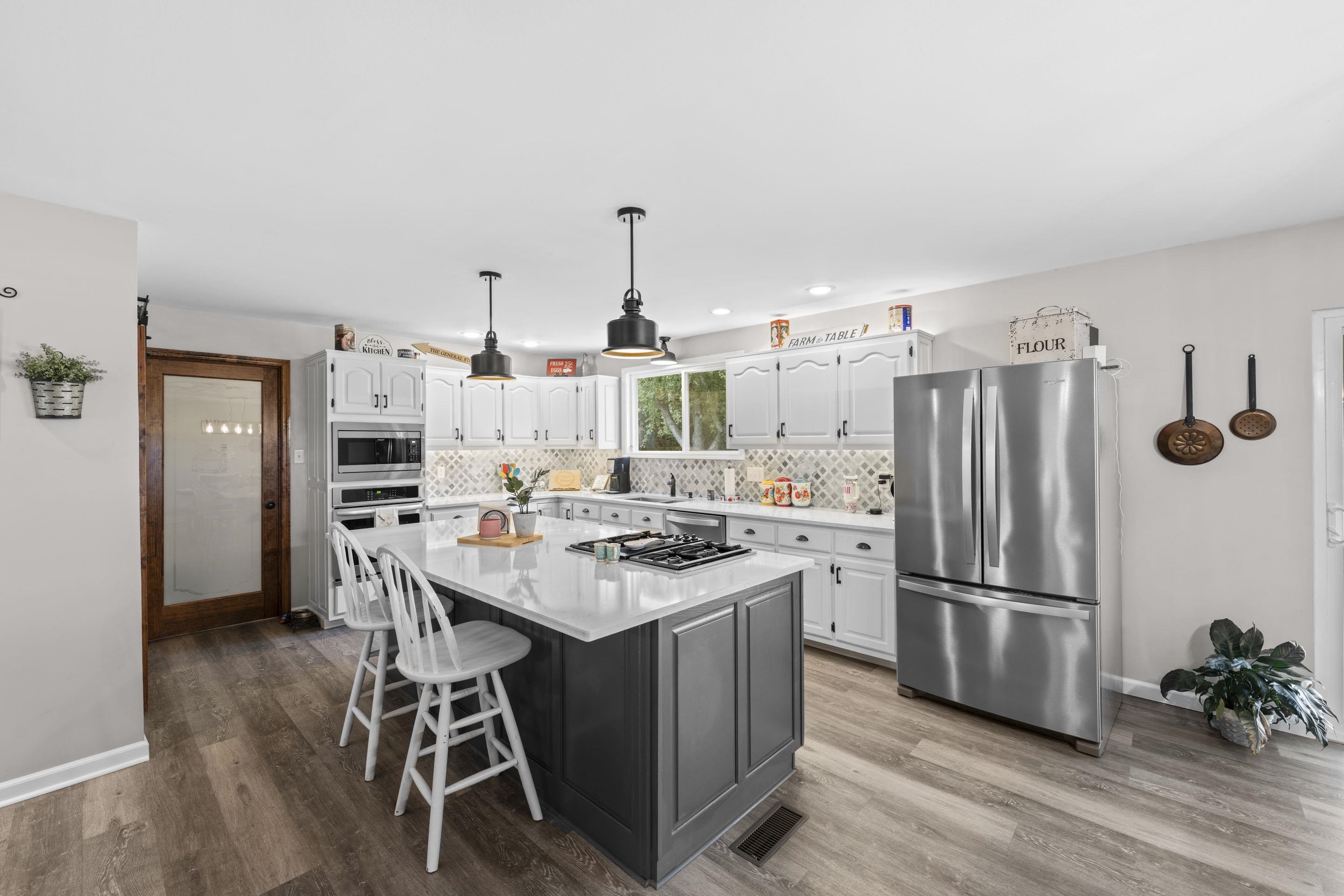 849 Belton Road Ripley, TN 38063 - Photo 15 of 40 a kitchen with stainless steel appliances a stove a refrigerator and a dining table