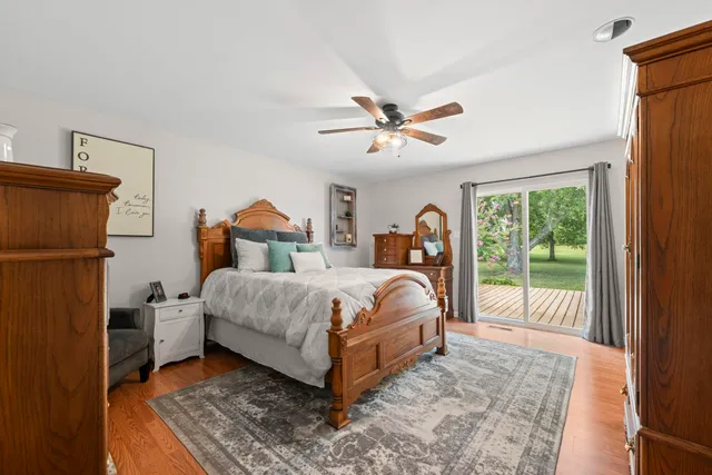 a bedroom with bed and wooden floor