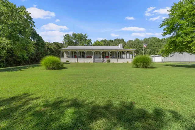 a view of a patio with table and chairs with wooden floor and fence