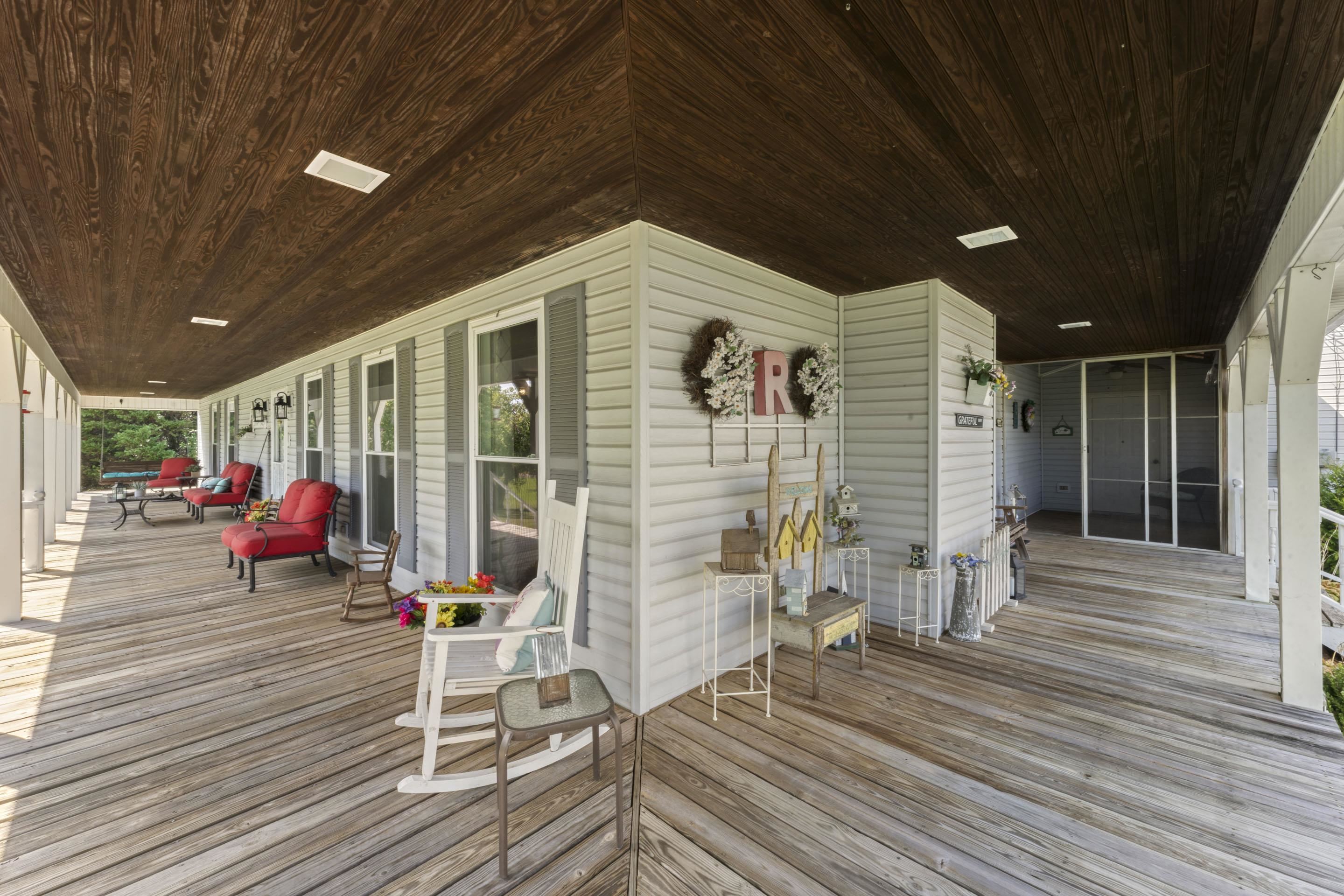 849 Belton Road Ripley, TN 38063 - Photo 4 of 40 a view of a patio with table and chairs with wooden floor and fence