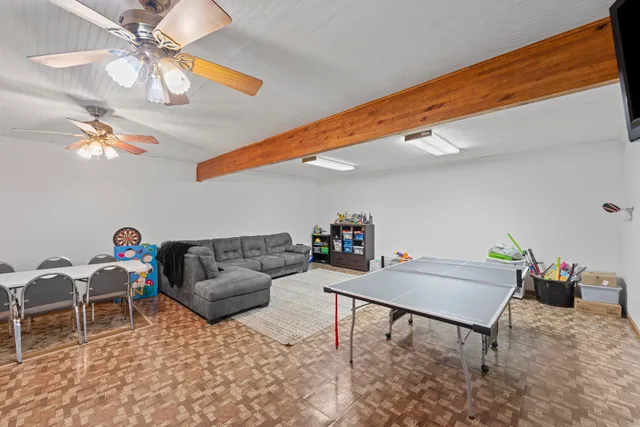 a view of hallway with wooden floor and flat screen tv