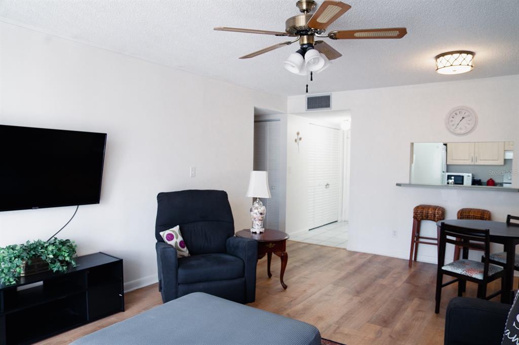 519 Albee Farm Road, Unit 110 Venice, FL 34285 - Photo 23 of 33 a living room with furniture and a flat screen tv