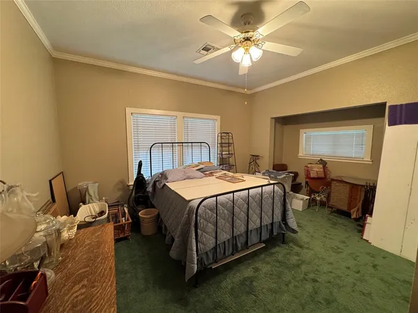 a spacious bedroom with a bed and a chandelier