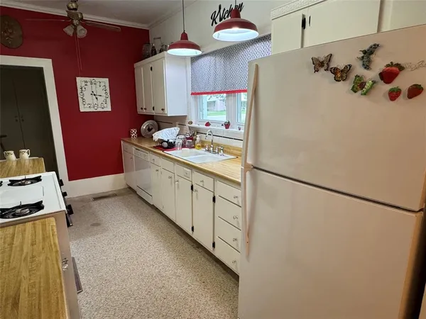 a kitchen with stainless steel appliances a refrigerator sink and cabinets